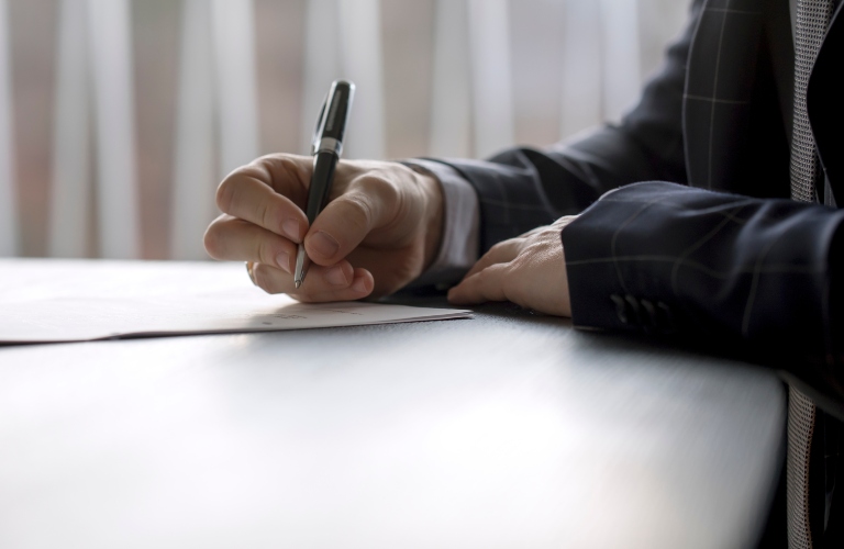 Man signing a document in a law office