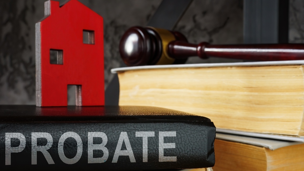 Probate law book and model of house on it