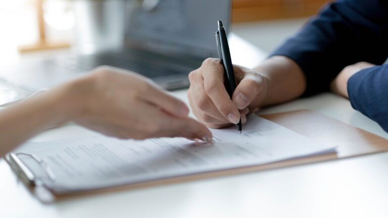Woman is signing documents