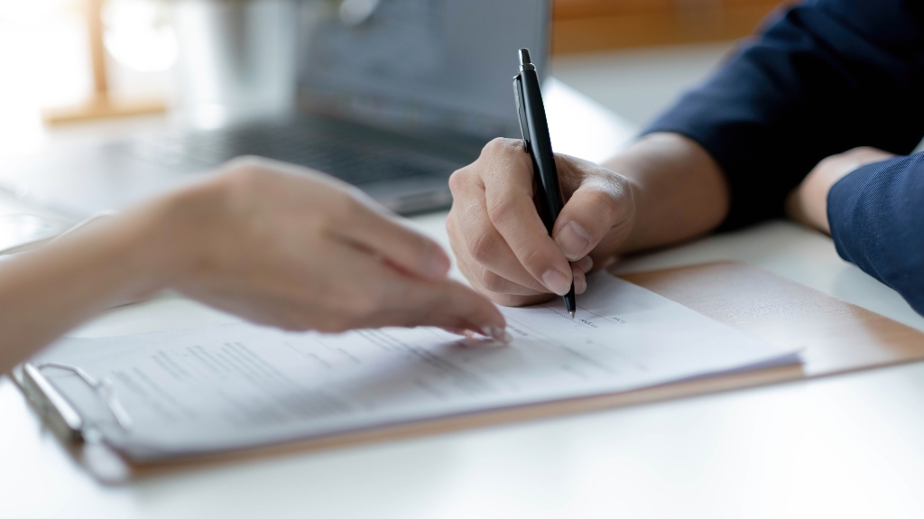 Woman is signing documents